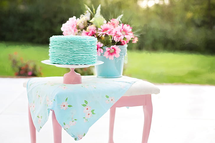 teal fondant cake on pink cake tray