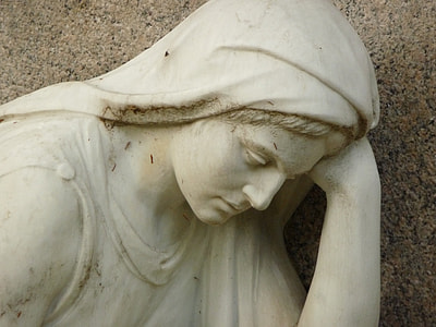woman leaning on left hand statue