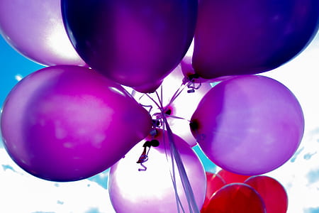 low angle photography of purple balloons
