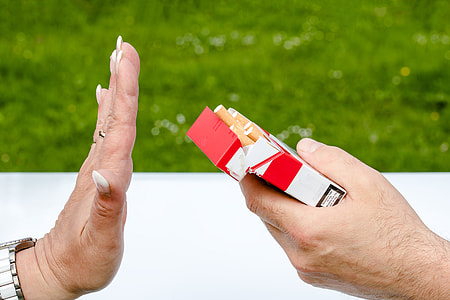 person holding flip-top cigarette box