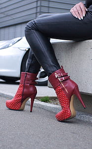 pair of red leather cone-heeled booties