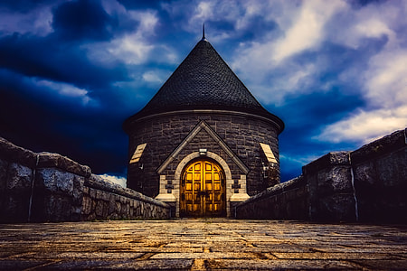 low-angle photography of black castle under dark clouds wallpaper