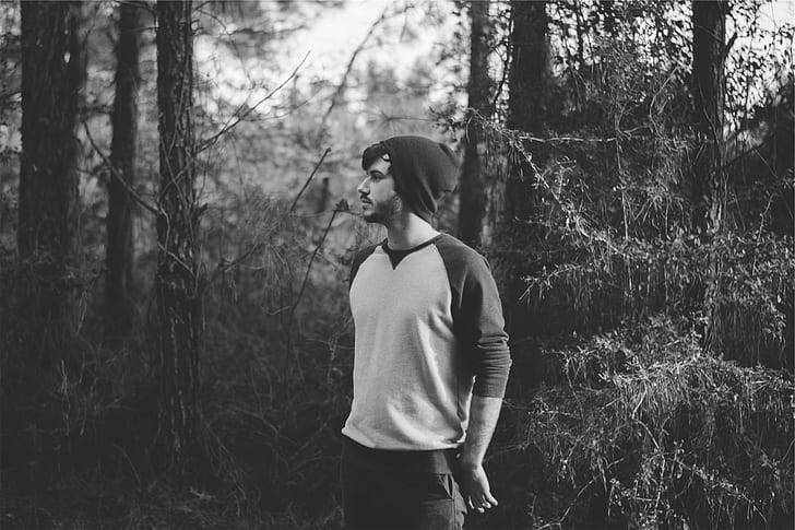 grayscale photography of man on forest