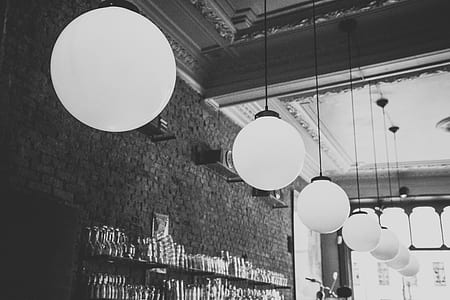 grayscale photo of pendant lamps