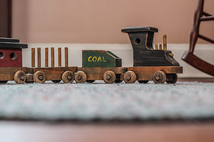 photo of brown and black miniature wooden toy train