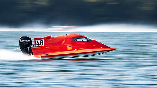 time lapse photography of red powerboat