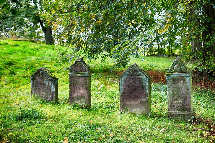 four gray concrete graves