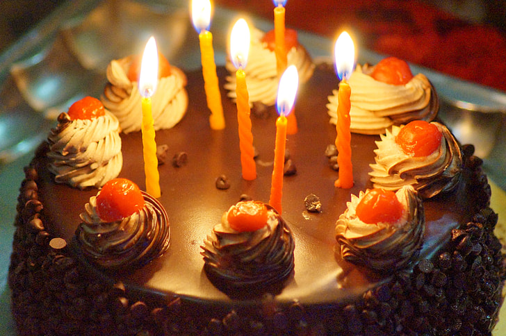 red candles on chocolate cake macro photography