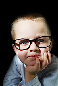 photo of boy wearing eyeglasses