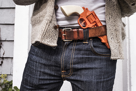 white and brown revolver on belt