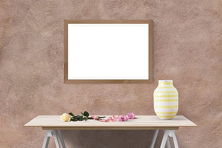 brown wooden framed white wall decor above white wooden table