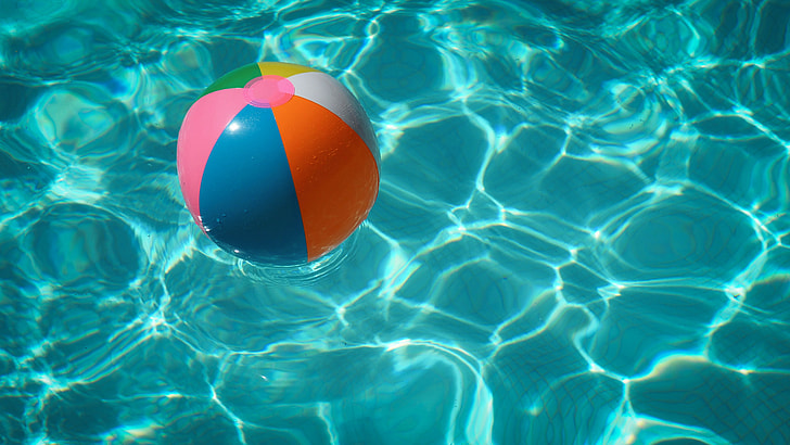 blue, pink, and orange inflatable ball on body of water