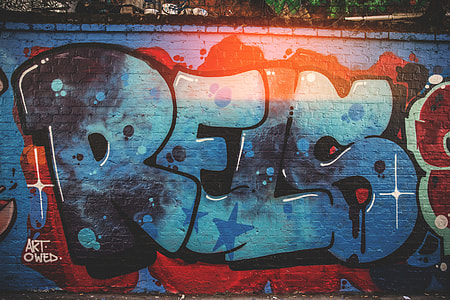 A brick wall covered in graffiti