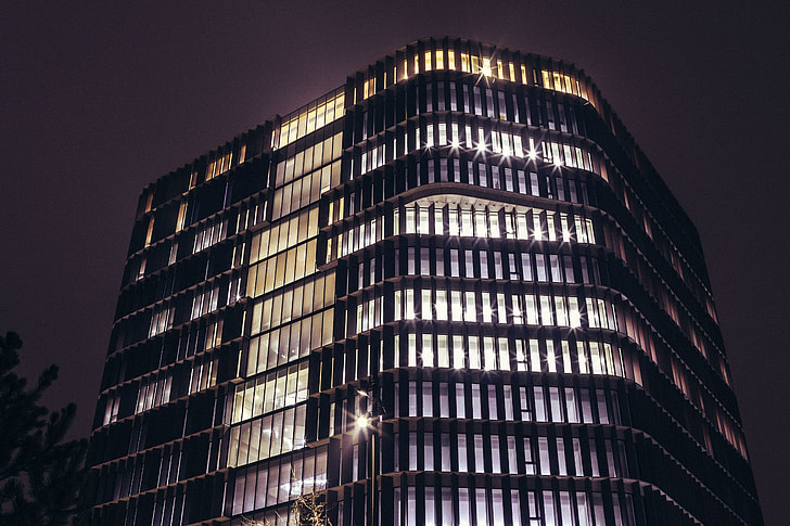 Office building at night with lights on