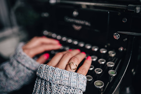 Woman typing on an old typewriter