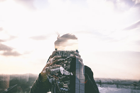 blending photography of a man and city skyline during daytime