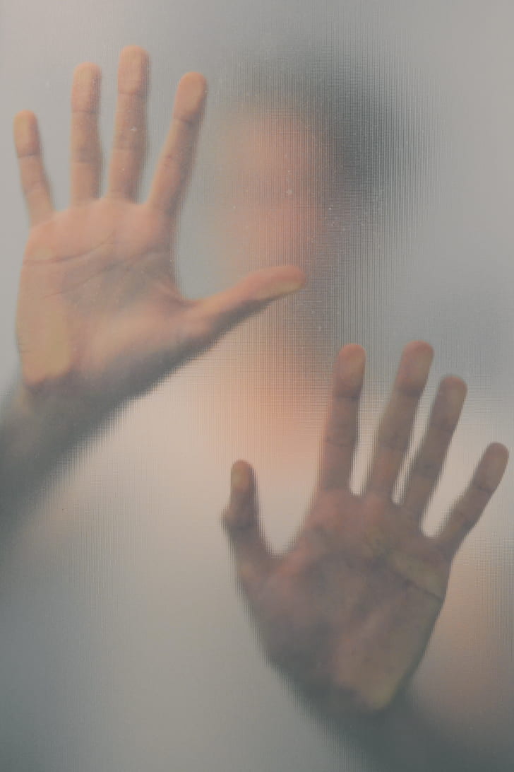 photo of person touching frosted glass