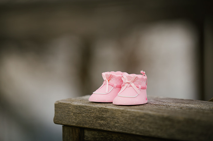 toddler's pair of pink shoes in selective color photography