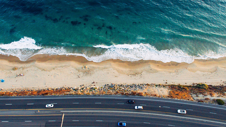 aerial photography of road beside the beach