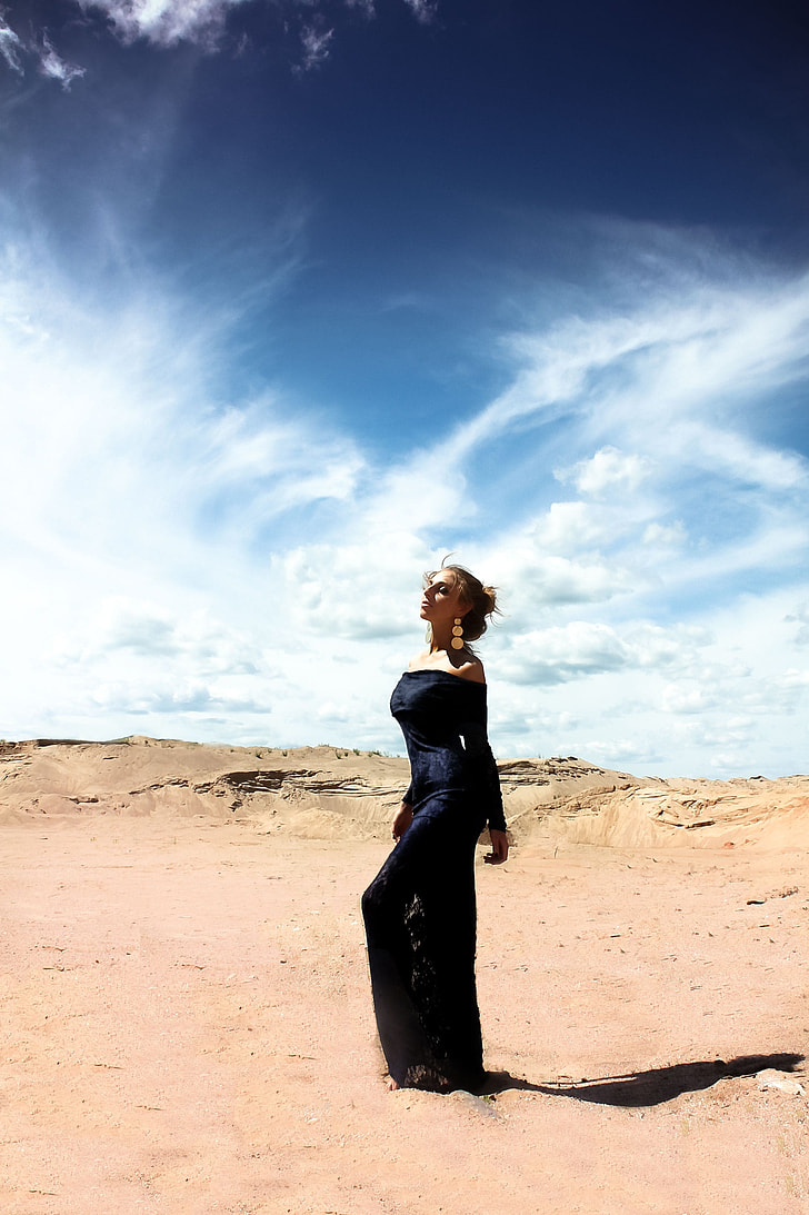 woman wearing black off-shoulder dress in the desert