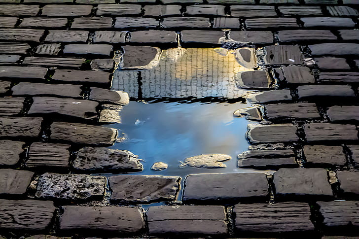water puddle on brick floor