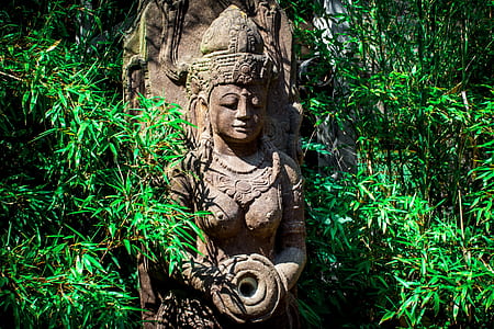 brown concrete Buddha statue in the forest during daytime