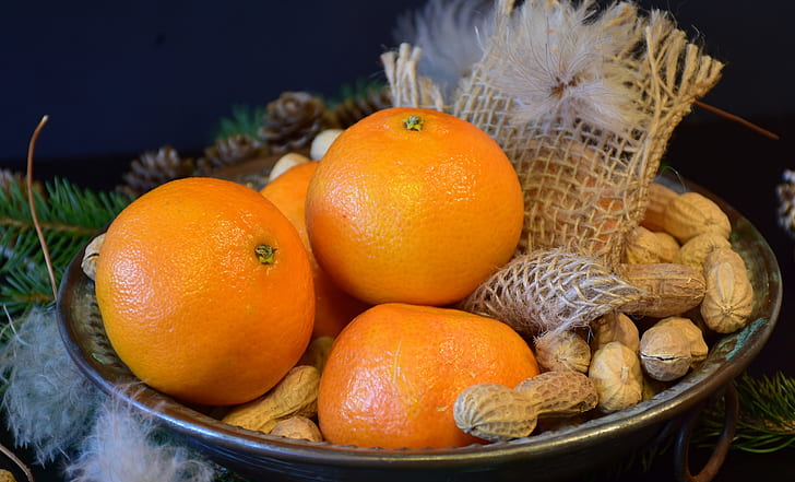 four orange fruits on bowl