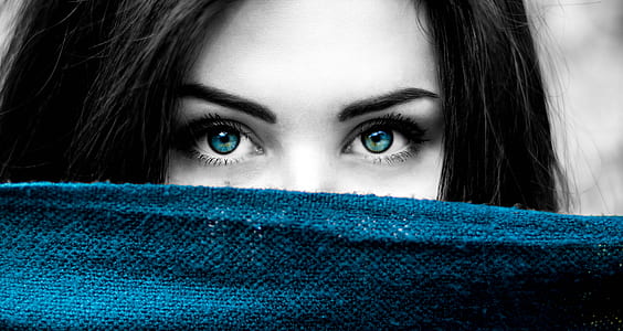 selective color photography of woman showing blue eyes and blue textile