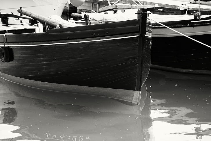 Gray Scale Photo of Boat on Body of Water