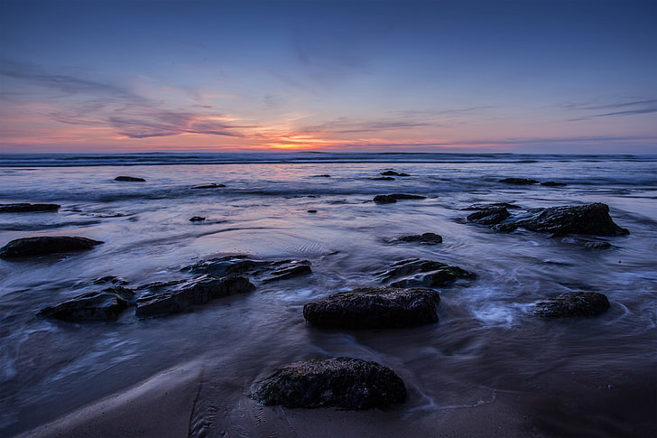Wide-angle seascape image taken at sunset on the Coast of Cornwall in the South of England. This shot was a two-second exposure to add some movement to the water