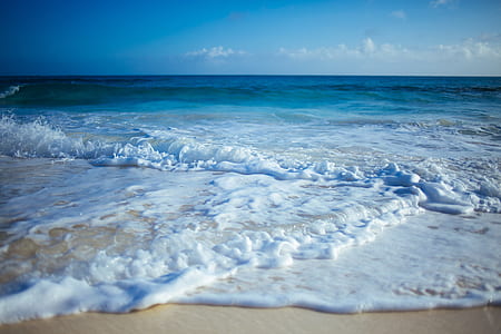 photo of seawaves on seashore during daytime