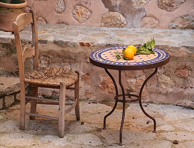 orange fruits on round brown patio table