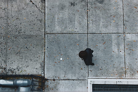 person walking on gray concrete walkway