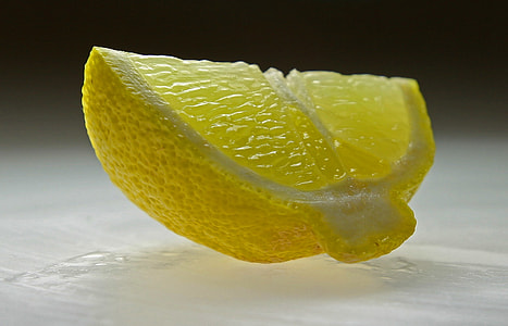 sliced lemon on white surface