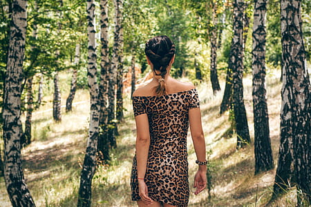 photo of woman wearing leopard print bodycon off-shoulder dress