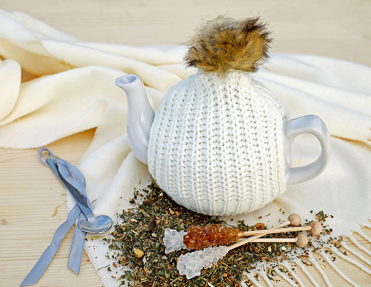 white ceramic teapot on textile