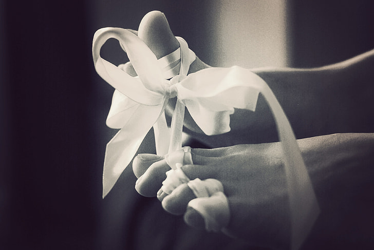 grayscale photo of ribbon tied toes
