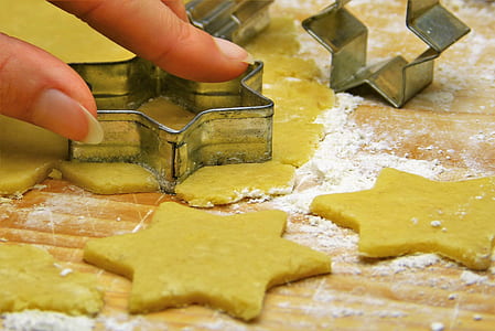 person holding gray star cookie cutter