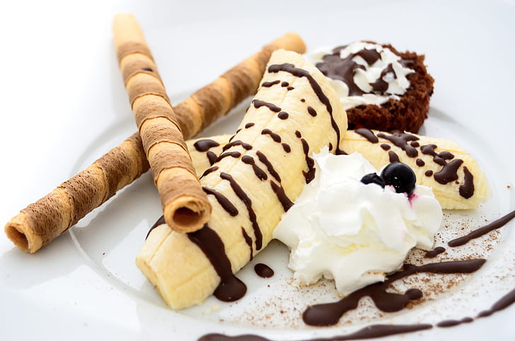 chocolate syrup on top of banana with wafer