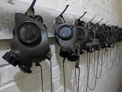 gray gas masks on hooks