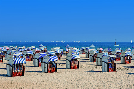 red and white booths on seashore during daytime