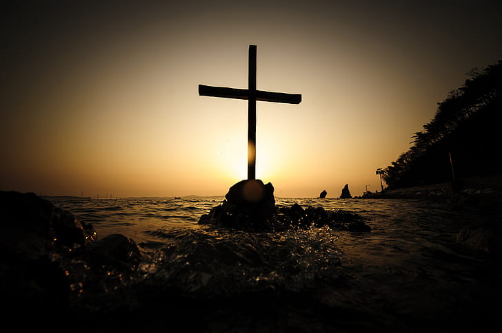 silhouette photo of cross in the middle of ocean