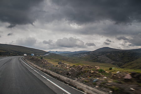 Road Near Brown Stone during Cloudy