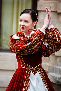 woman wearing red and white traditional dress clapping her hands