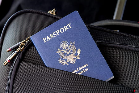blue Passport and black bag