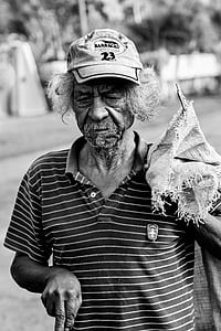 Grayscale Photography Of Man Wearing Polo Shirt And Holding Sack