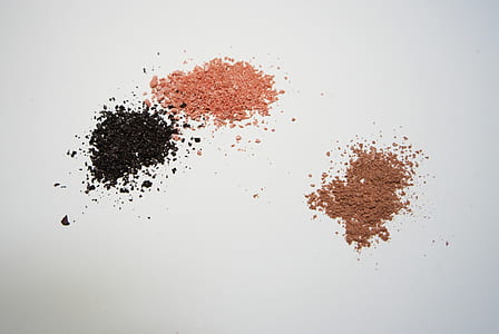 three brown, pink, and black grains