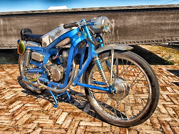 high-saturated photography of customized classic blue motorcycle