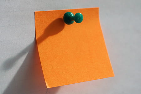 orange note with green pin