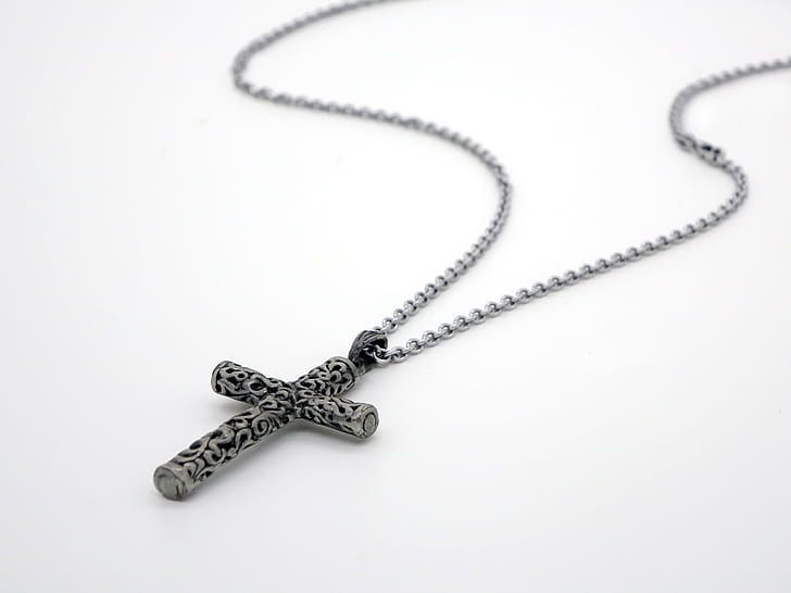 silver-colored and black cross pendant in silver-colored link necklace